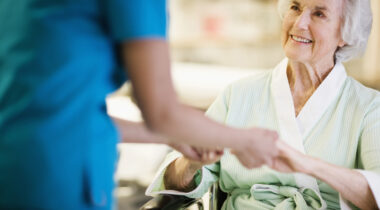 Nurse Holding Hands with Elderly Patient