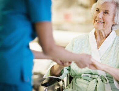 Nurse Holding Hands with Elderly Patient