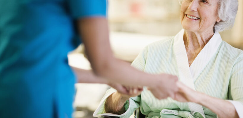 Nurse Holding Hands with Elderly Patient